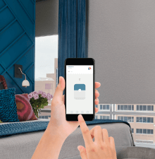 a person is holding a cell phone to control window Blind