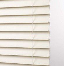 a close up of a white blind and a routeless slats
