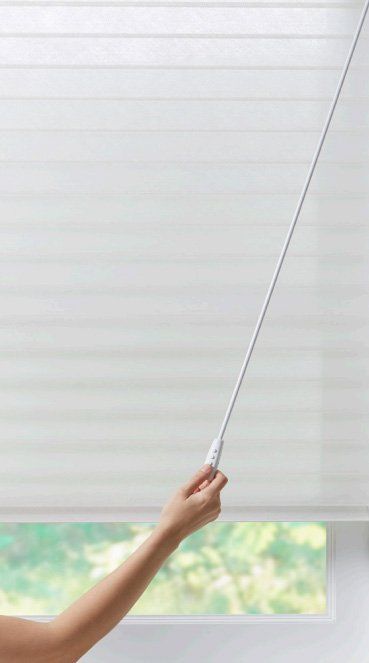 Cellular honeycomb shades with a power wand available at affordable blinds