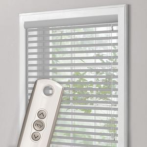 a window with blinds and a remote control on it .