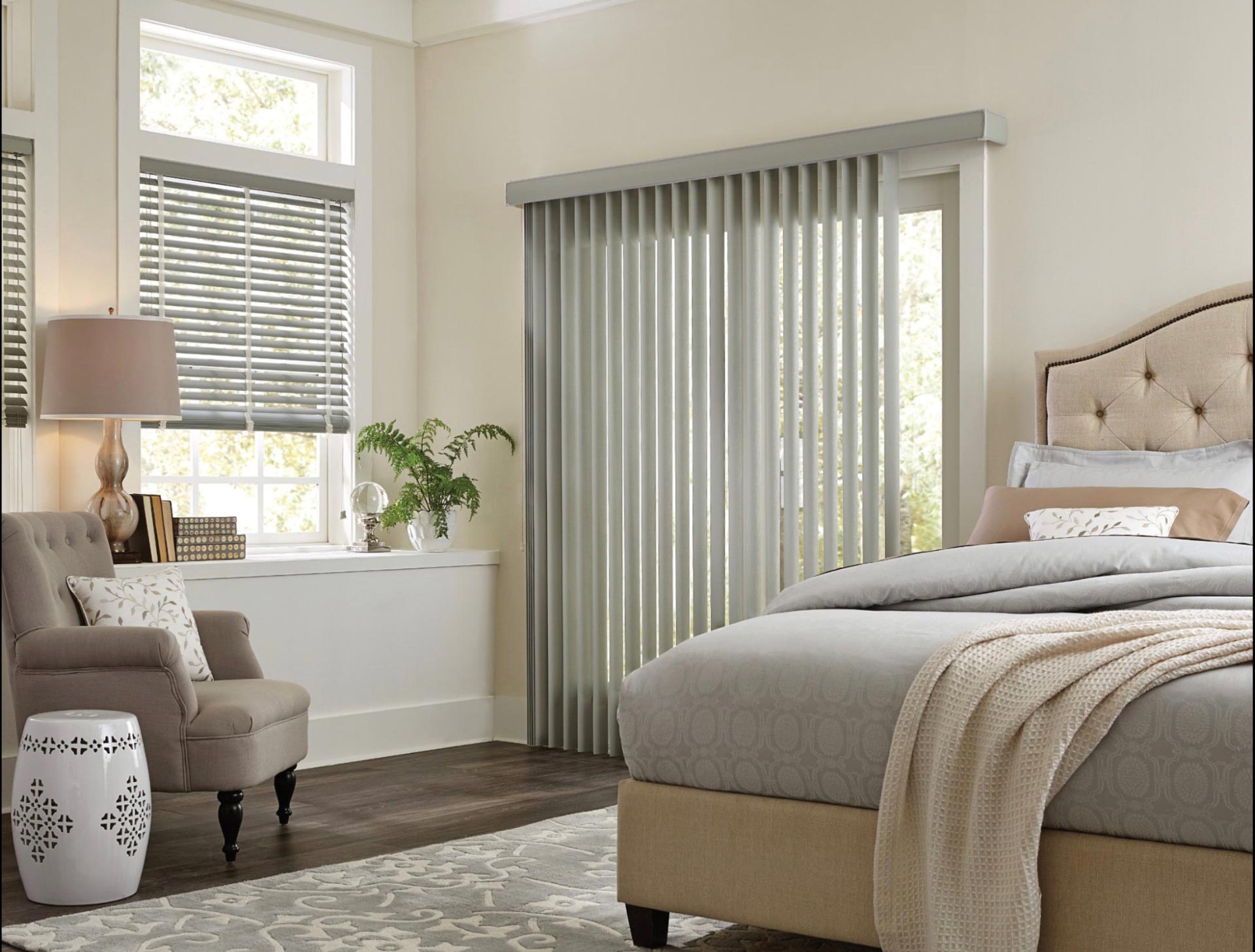 a bedroom with vertical blinds and a bed