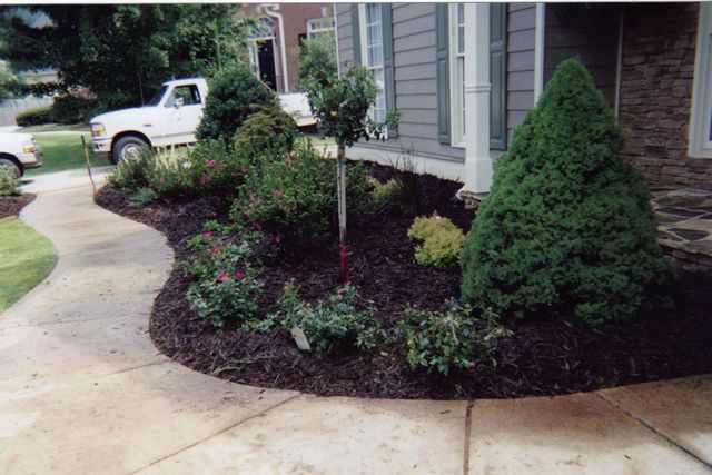A white truck is parked in front of a house