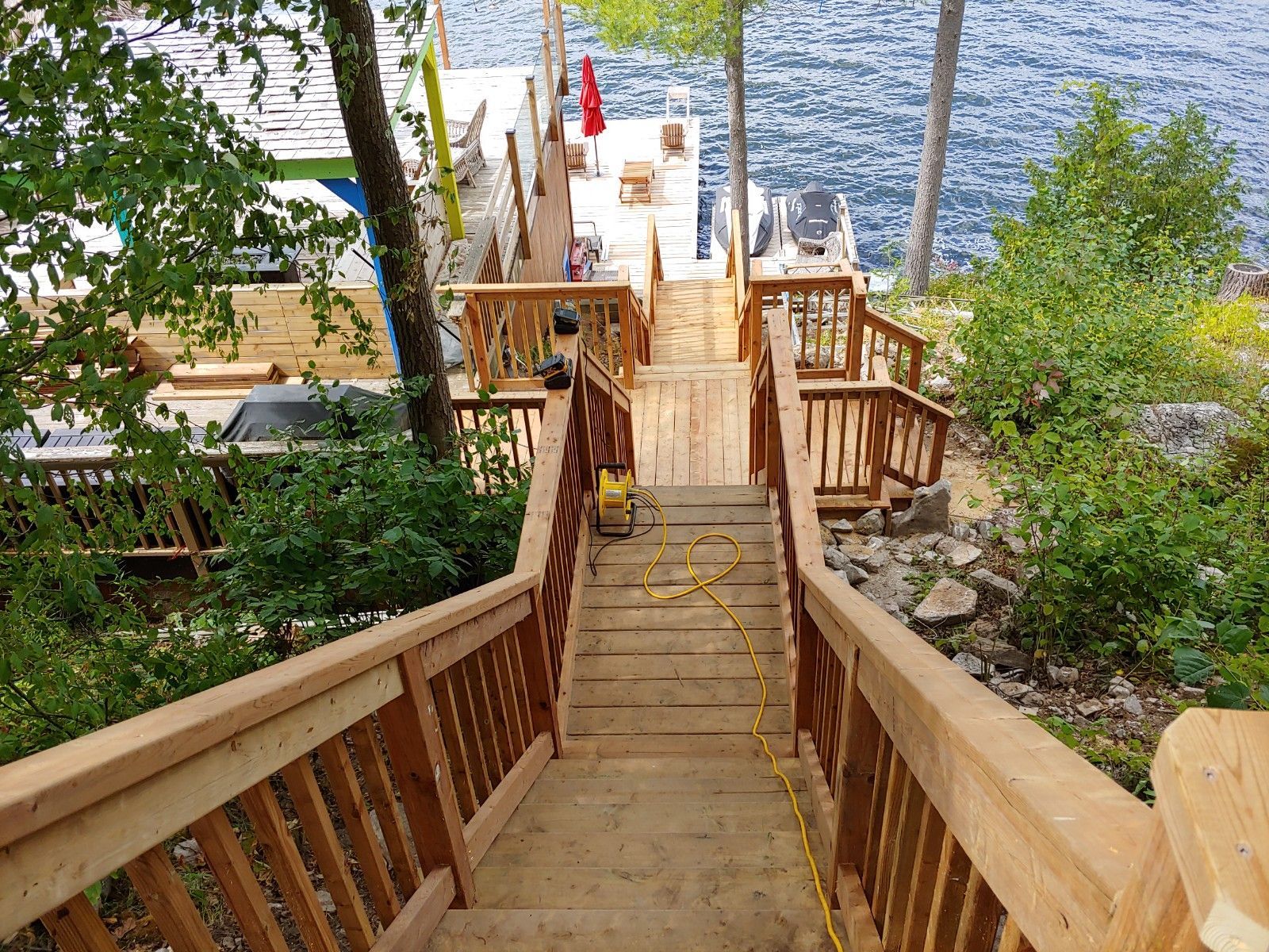 A wooden staircase leading up to a dock on a lake.