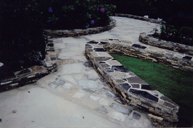 A stone walkway with a grassy area in the background