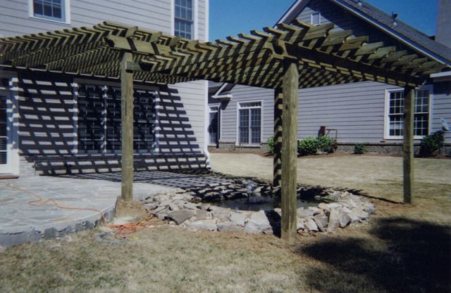 A house with a pergola in front of it