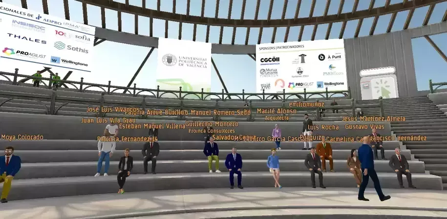 Virtual audience in a large amphitheater, attending a conference with logos displayed on large screens.
