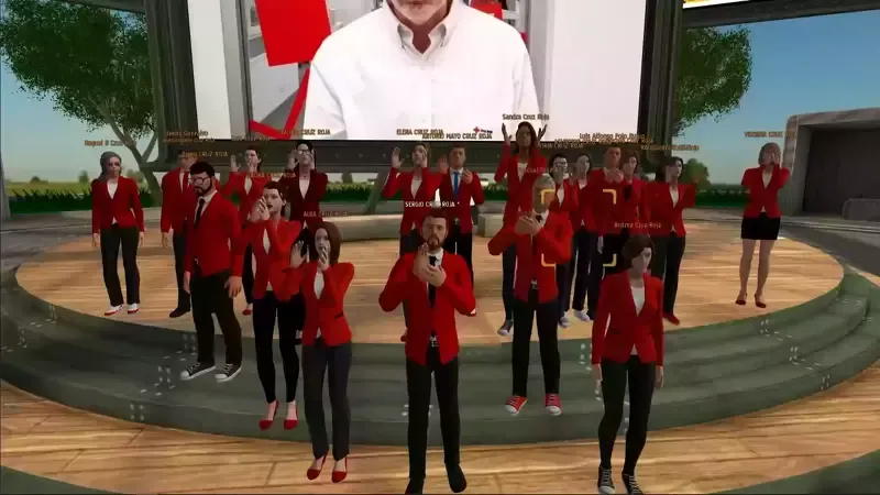 Group of avatars in red jackets, on a virtual stage, facing a screen with a person's image.