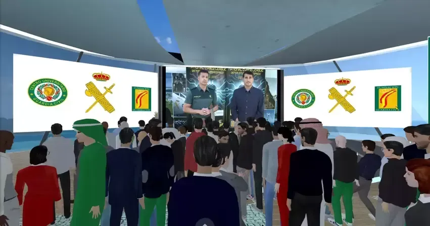 Two men presenting to a crowd in a virtual reality setting, logos on screens behind them.