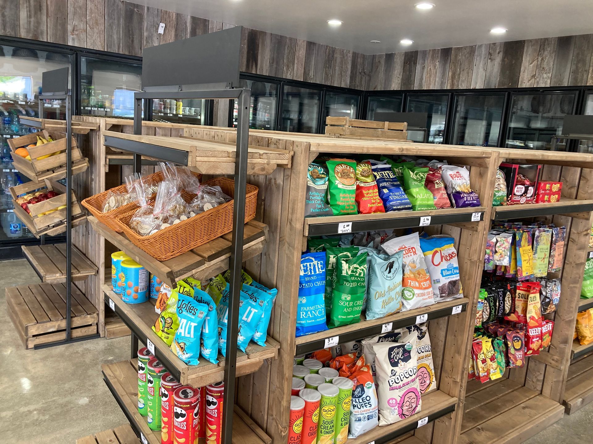 Wide view of our store interior featuring aisles of snacks and drinks.
