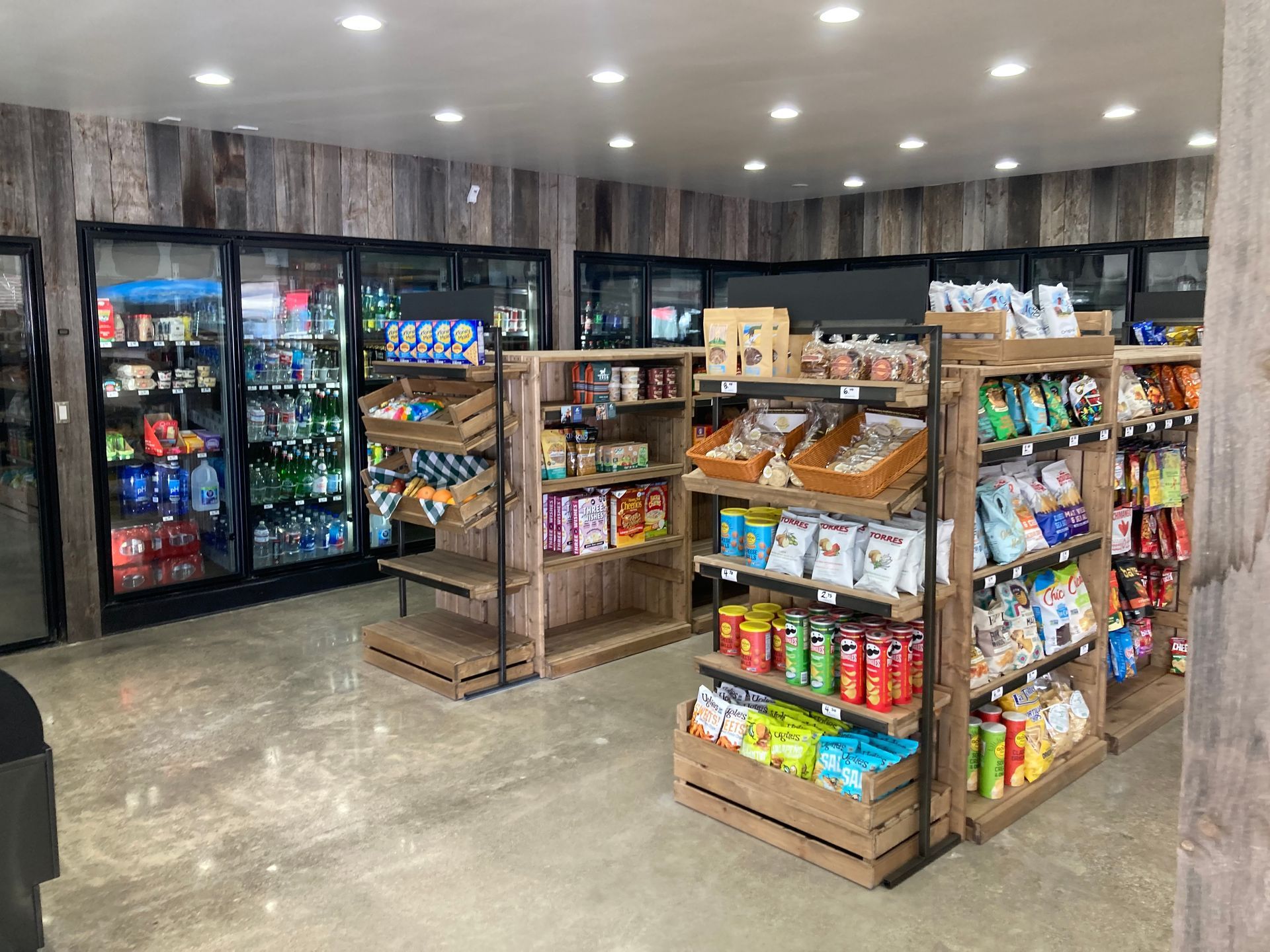 Wide view of our store interior featuring aisles of snacks and drinks.