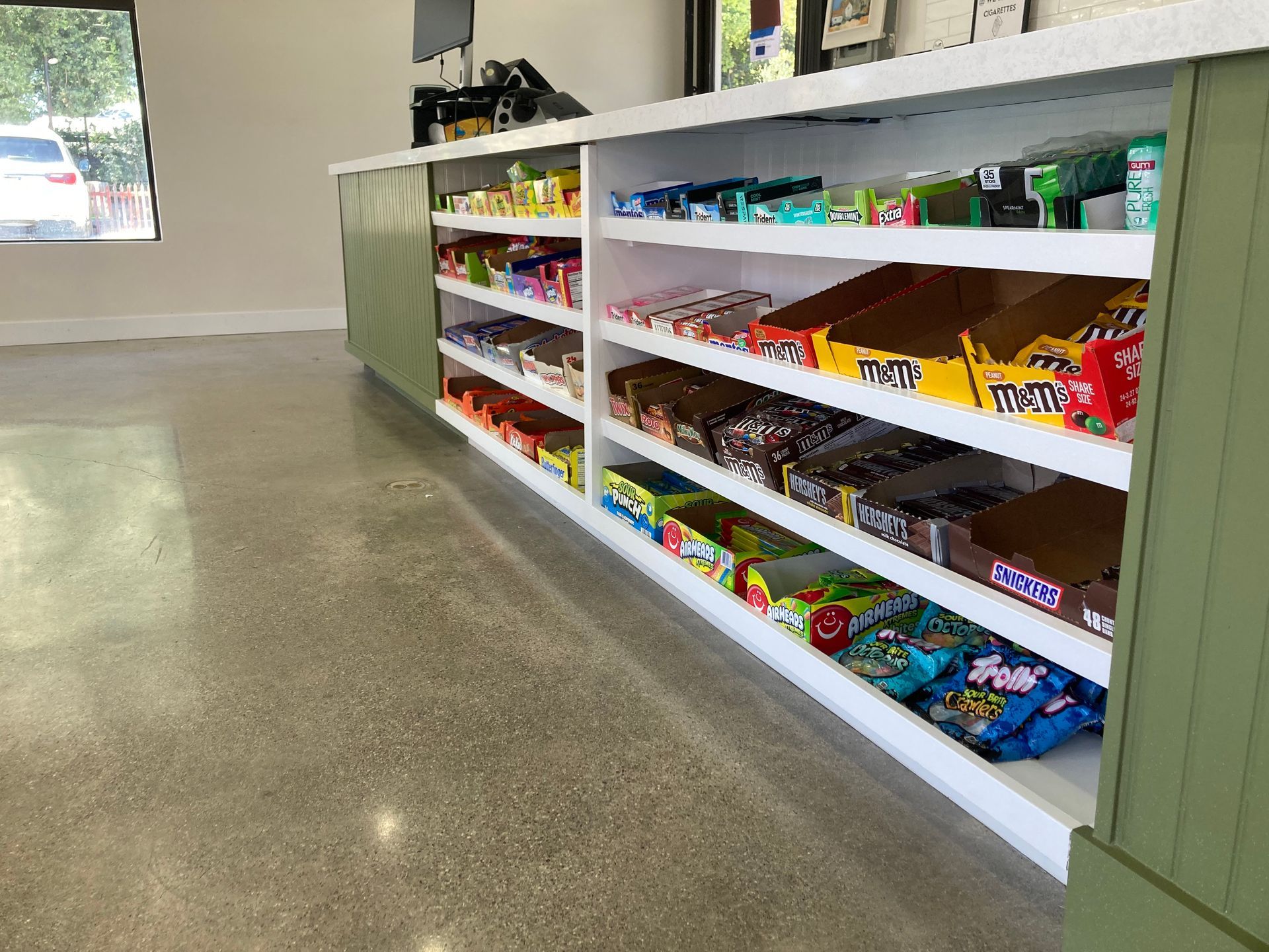 Store interior with shelves filled with a variety of candies.