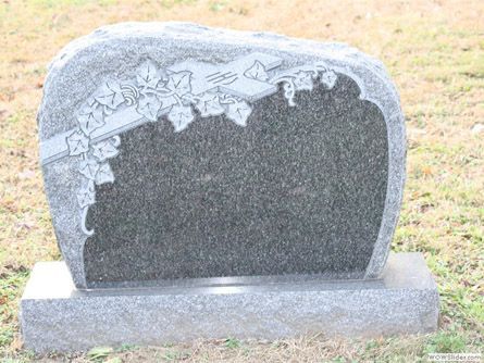 a gravestone in a cemetery with ivy on it .