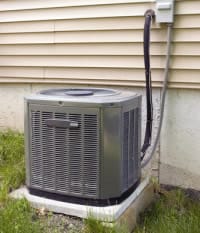 air conditioning unit on pad outside of home