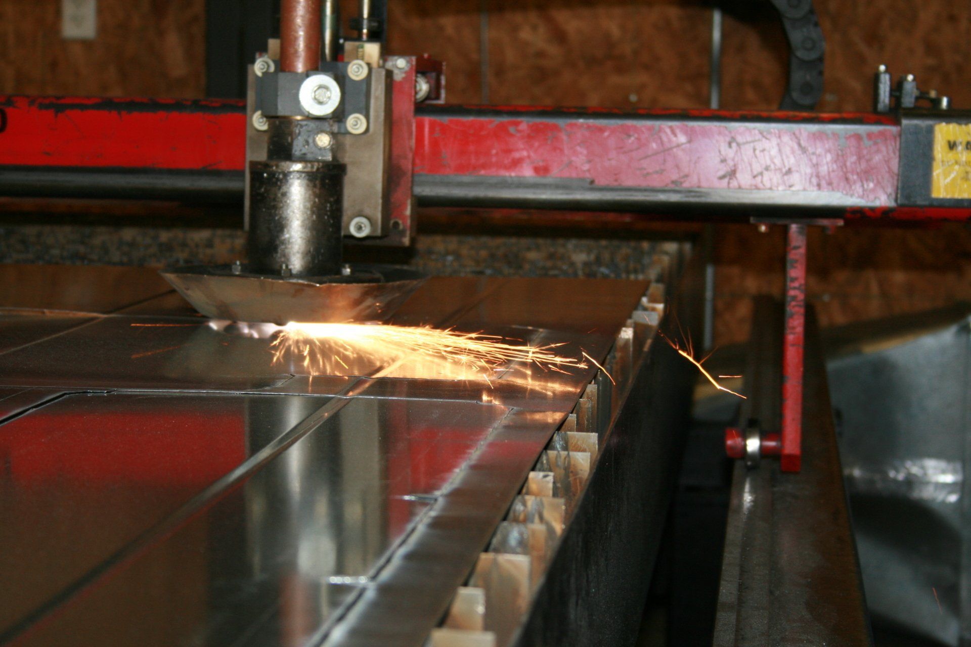 Plasma machine cutting metal.