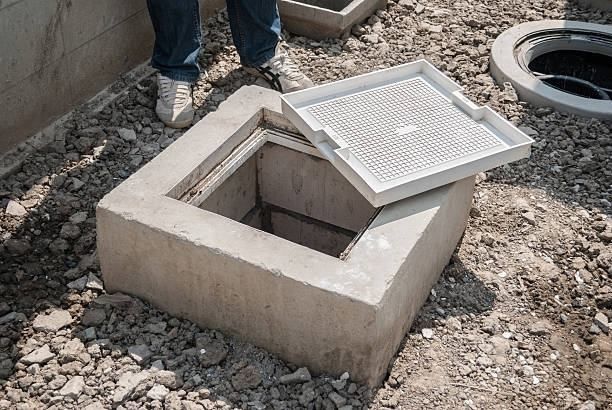 A manhole cover is sitting on top of a concrete block.