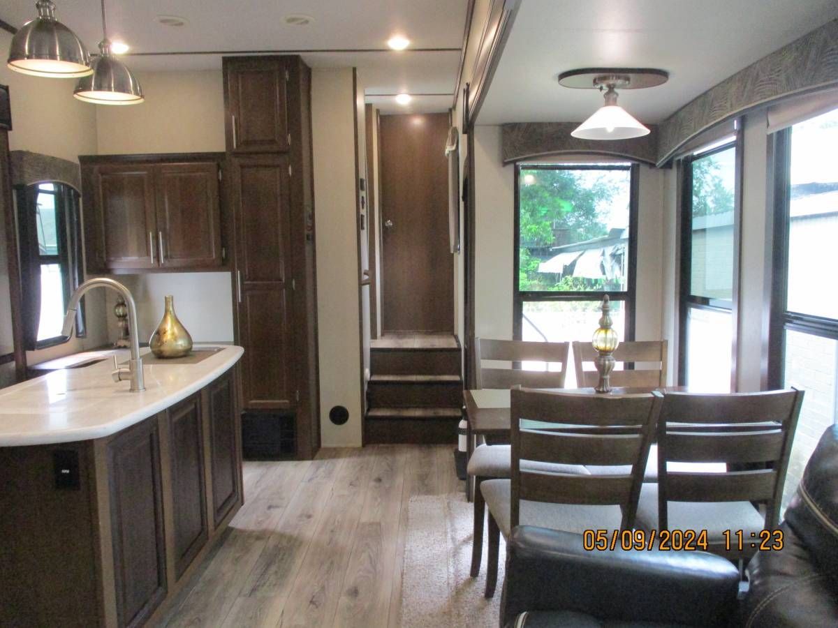 A kitchen with a dining table and chairs in it