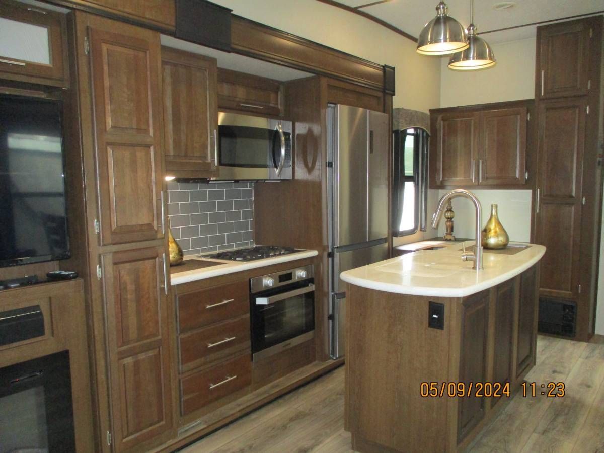 A kitchen with wooden cabinets and stainless steel appliances
