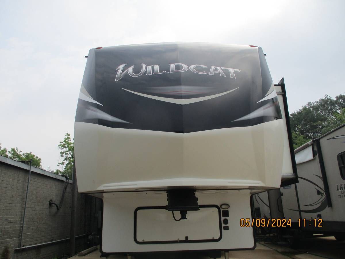 A white and black rv with the word wildcat on the front