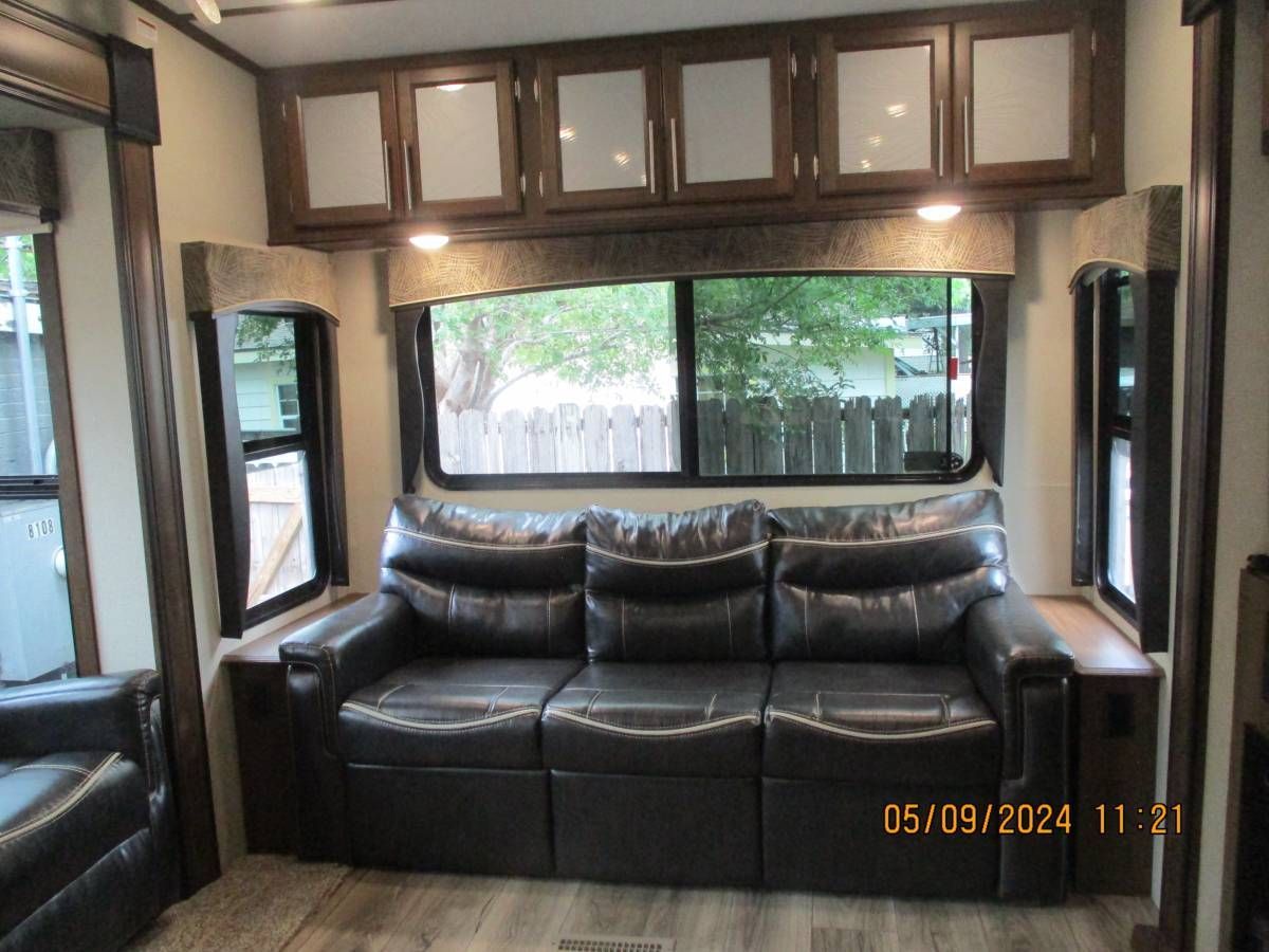 A living room with a couch and a window