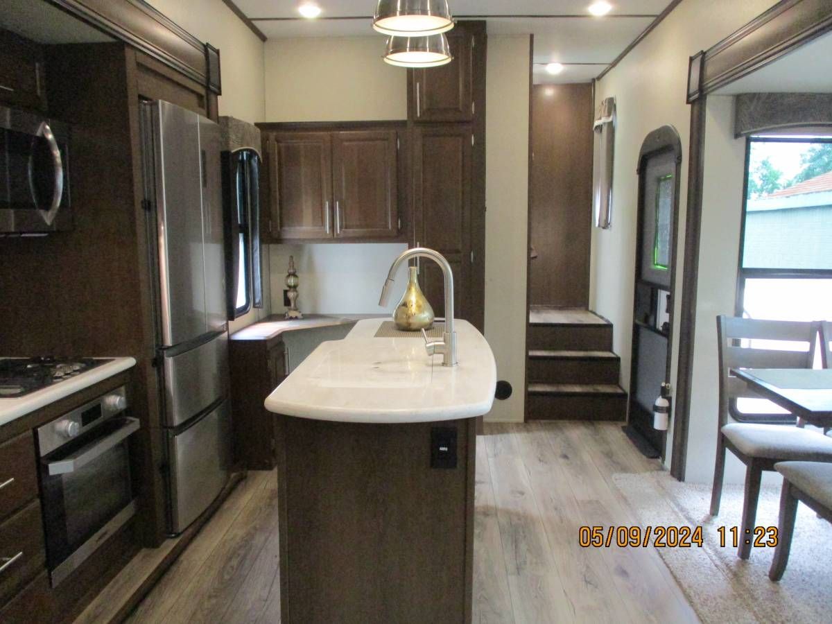 A kitchen with stainless steel appliances and wooden cabinets