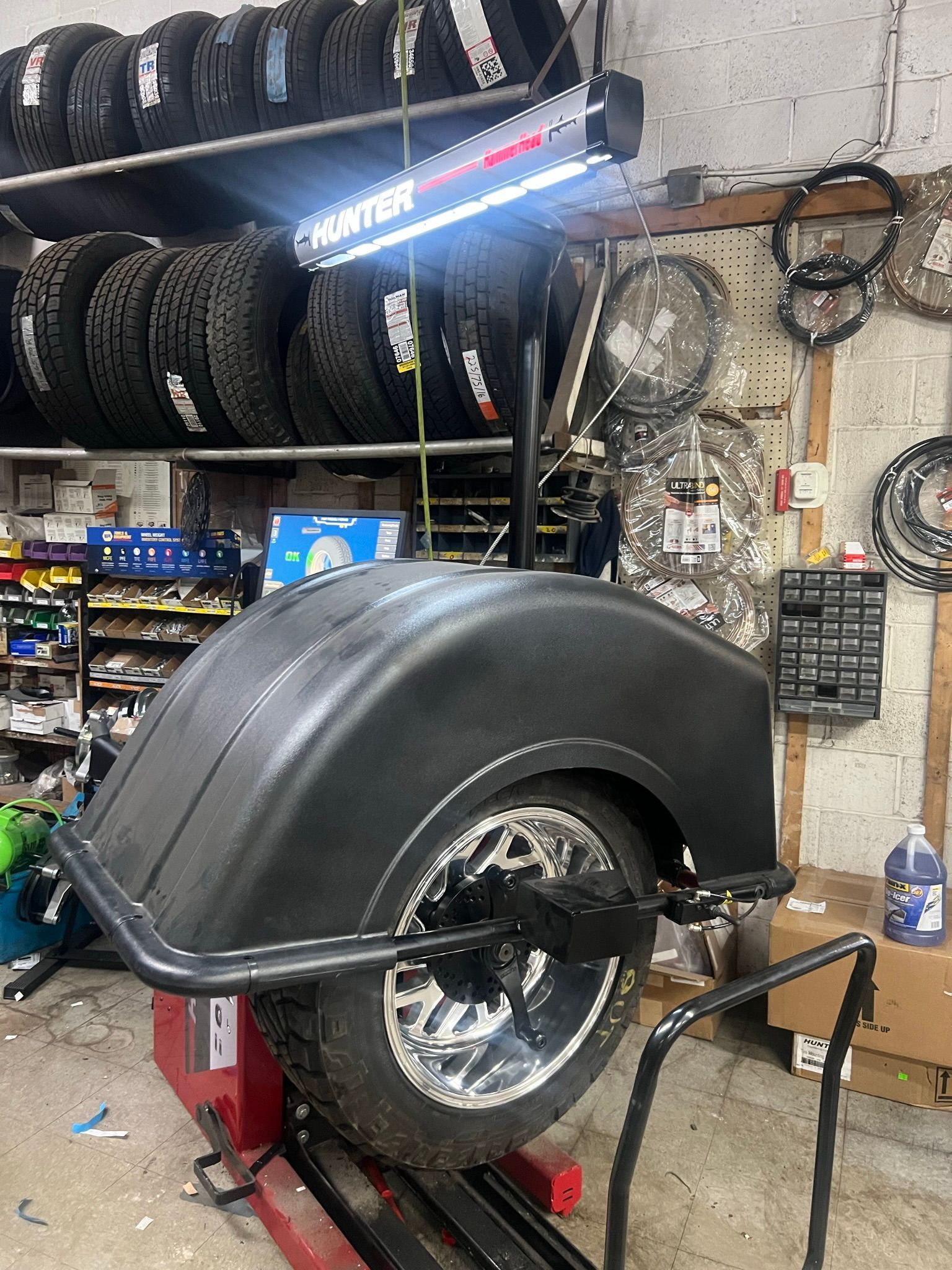 A tire is being balanced in a garage.