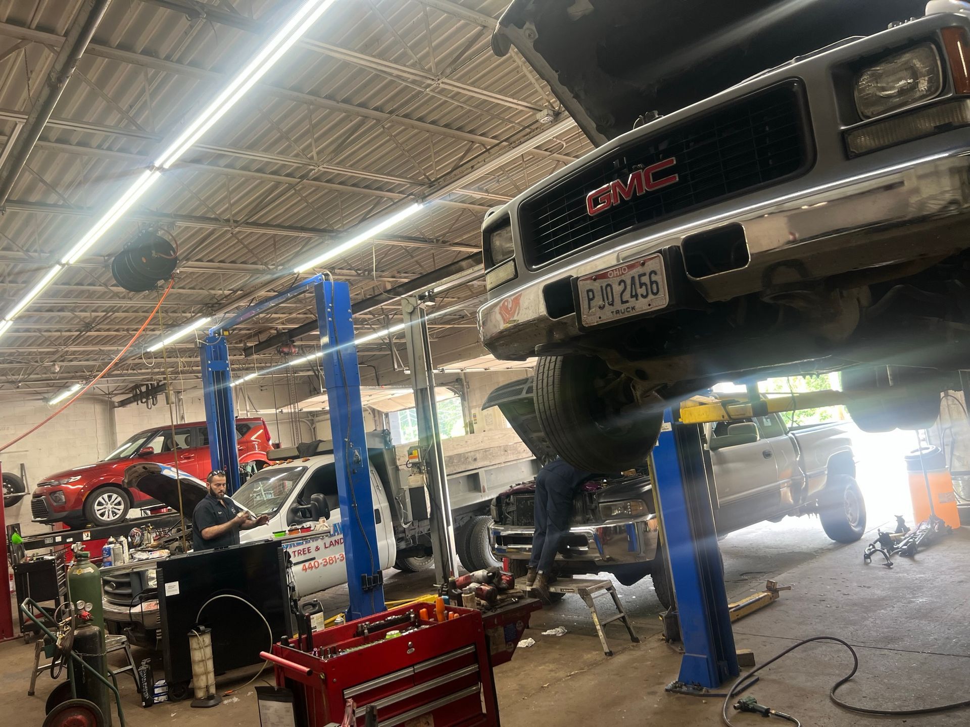 A GMC truck is being worked on in a garage.
