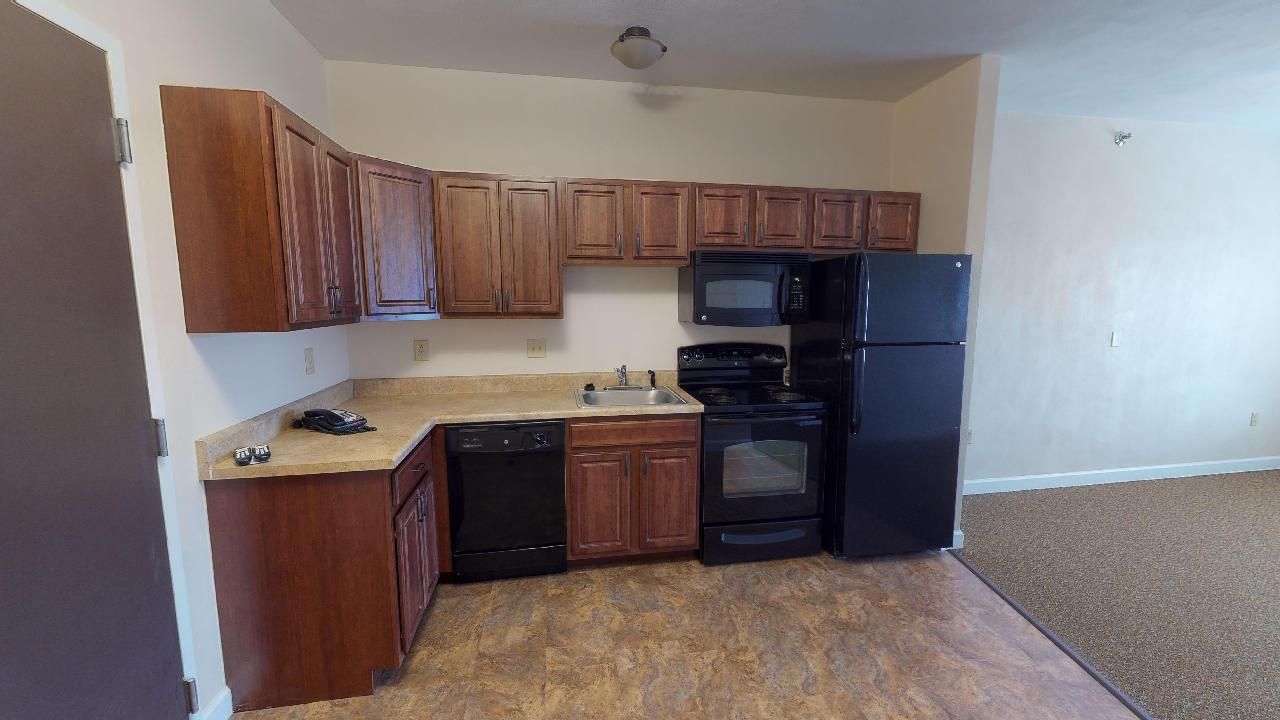 A kitchen with a refrigerator , stove , dishwasher , microwave and sink.