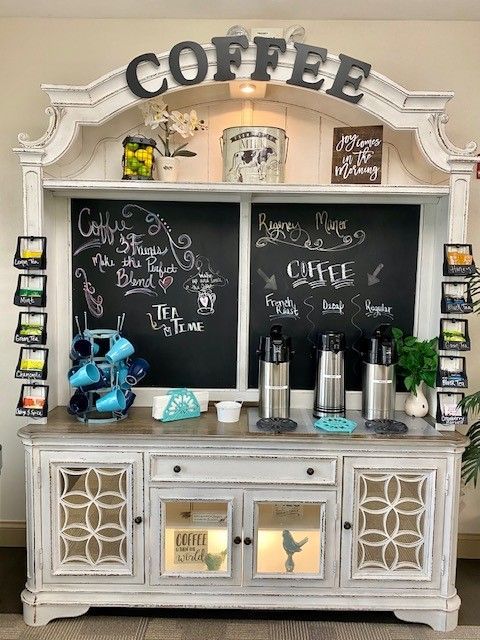 A coffee bar with a chalkboard and a buffet table.