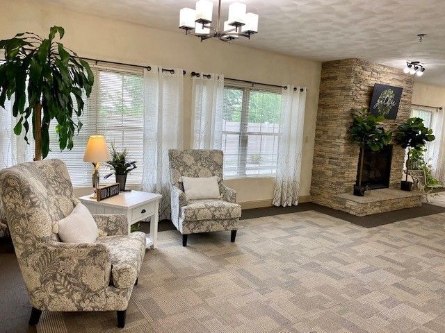 A living room with two chairs and a fireplace.