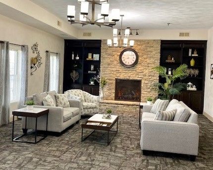 A living room filled with furniture and a fireplace.