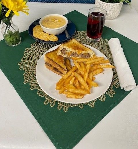 A plate of food with a sandwich and french fries on a table