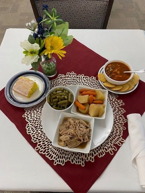 A table topped with plates of food and a bowl of soup