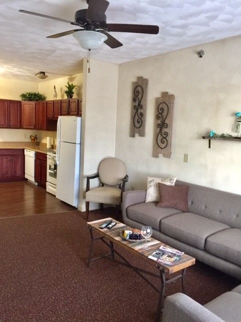 A living room with a ceiling fan and a couch