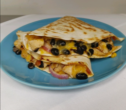 Two quesadillas on a blue plate on a table