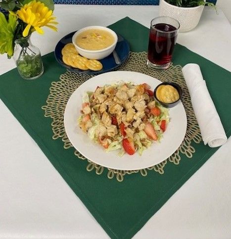 A plate of food is sitting on a green place mat on a table