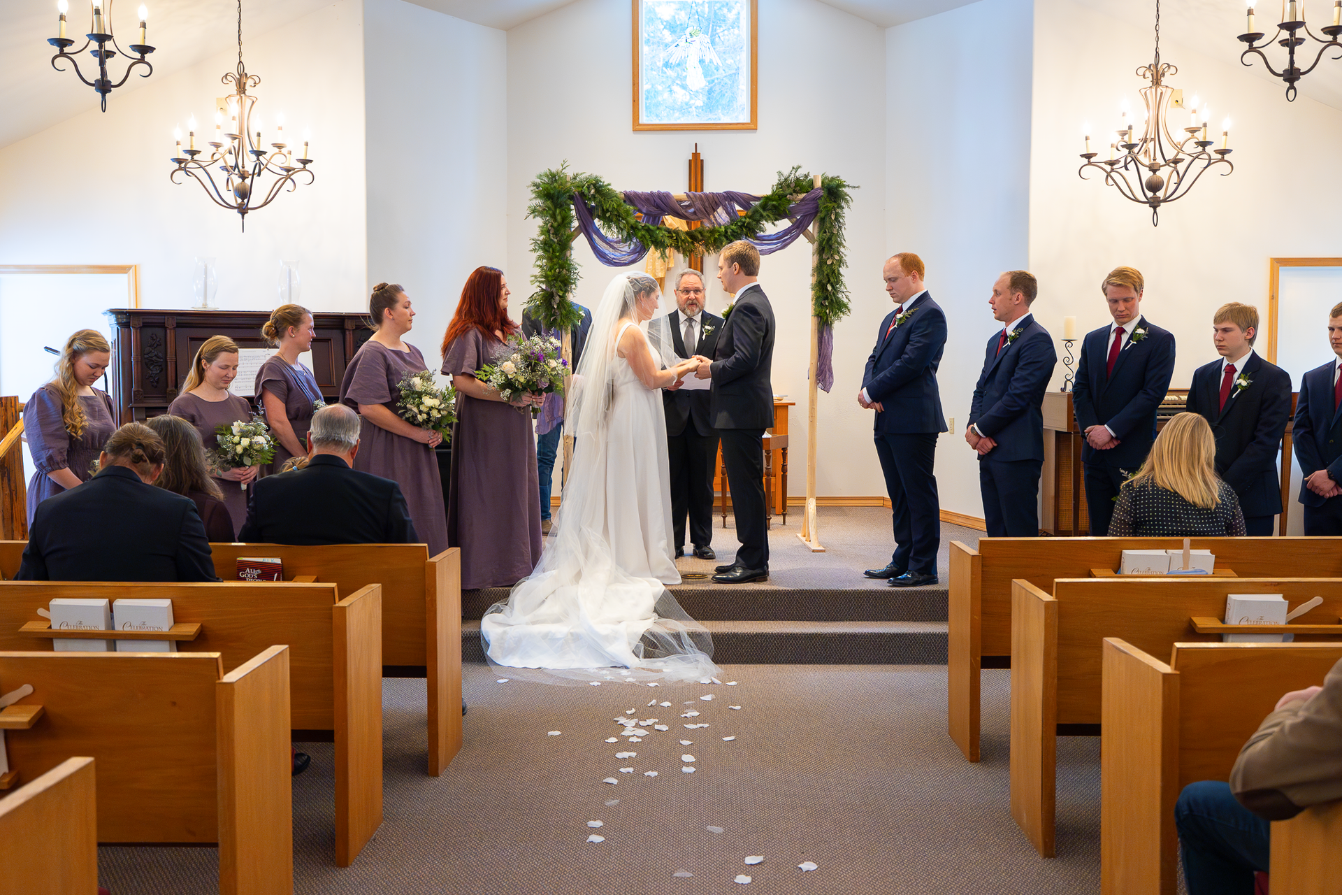 Wedding party in front of a church alter