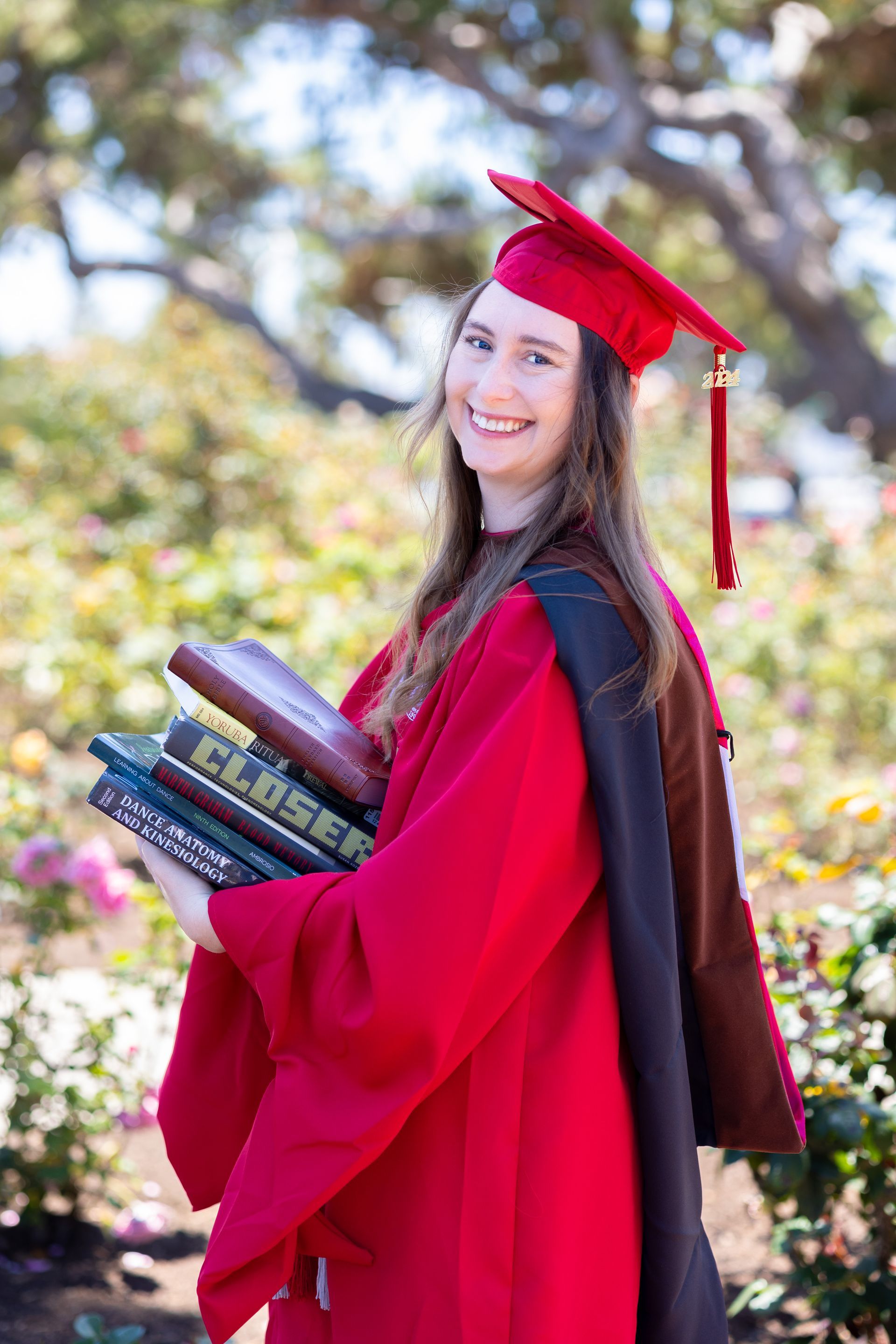 Graduating woman with her study books