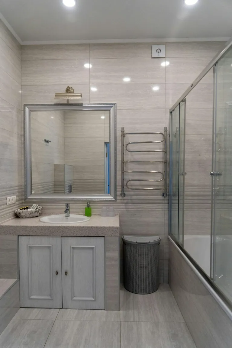 A bathroom with a sink , mirror , and bathtub.