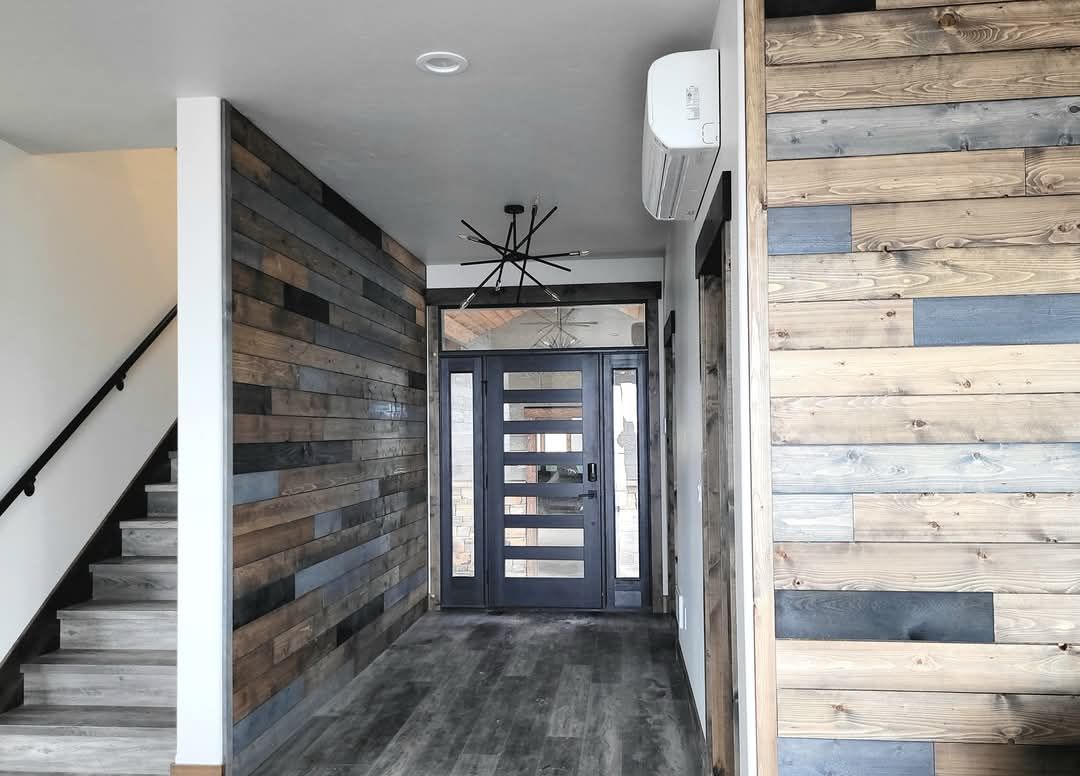 Stone chimney with dark wood and metal framing against a cloudy sky.