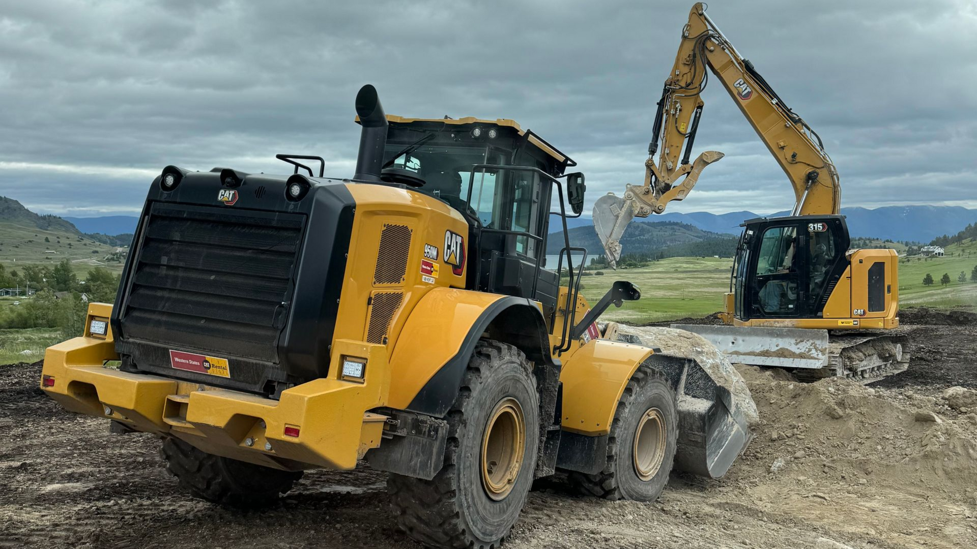 Yellow excavator on a worksite under a cloudy sky.