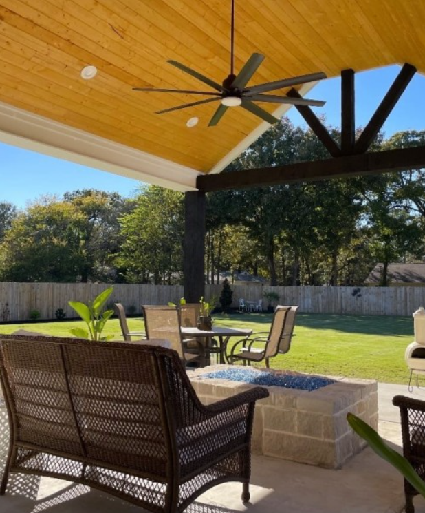 A patio with a ceiling fan hanging from the ceiling