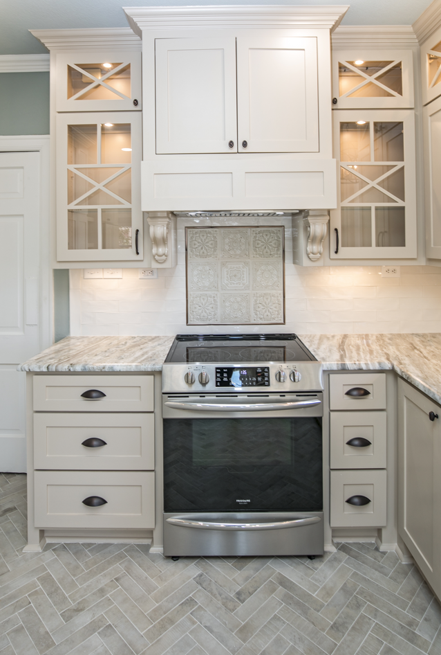 A kitchen with stainless steel appliances and white cabinets