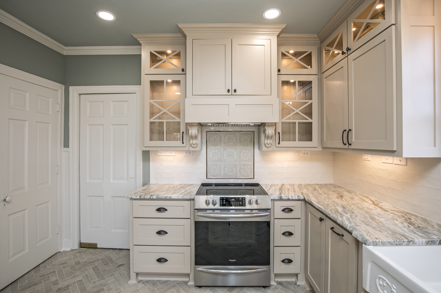 A kitchen with stainless steel appliances and white cabinets