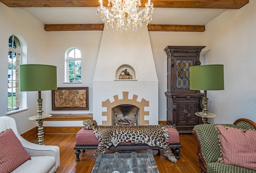 A living room with a fireplace and a chandelier