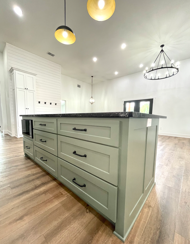 A kitchen with a large island and lots of drawers.