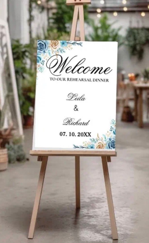 Wedding welcome sign on an easel. Blue and gold floral design with 
