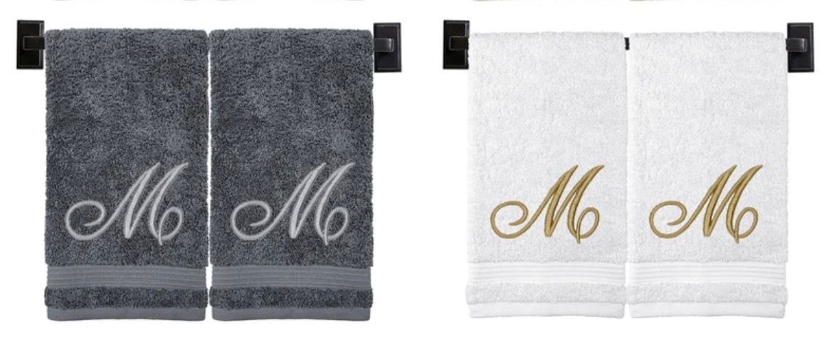 Two sets of monogrammed hand towels. Gray towels with white embroidery and white towels with gold embroidery.