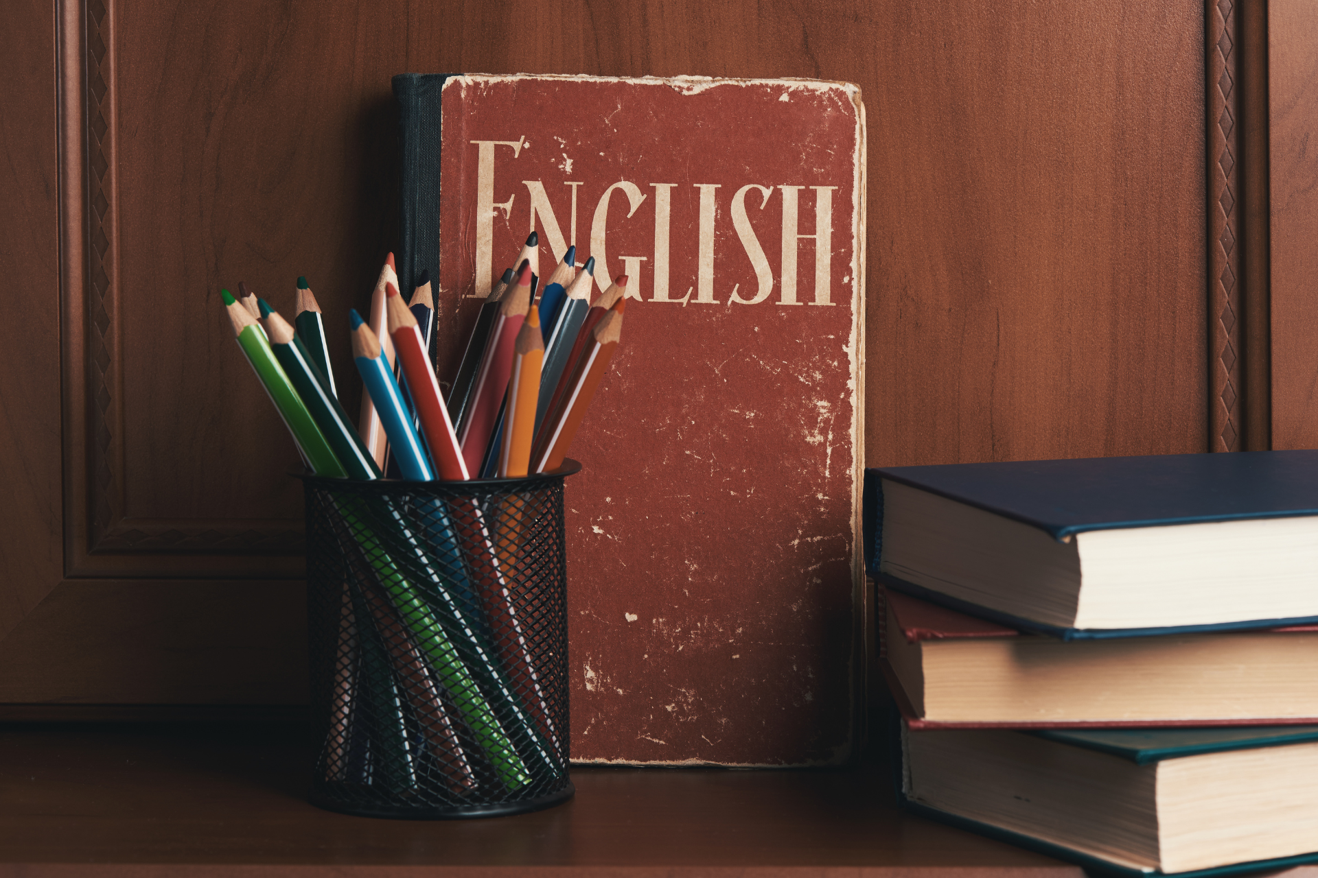 A stack of books next to a book titled english