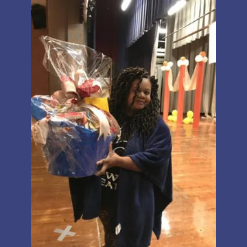 A woman in a blue poncho is holding a blue basket