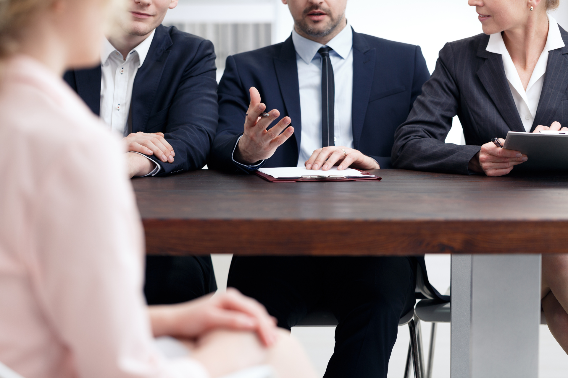 A group of people are sitting around a table having a meeting.